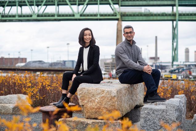 Science Rehashed co-hosts Shen Ning and Mehdi Jorfi pose for a photo sitting on a rock