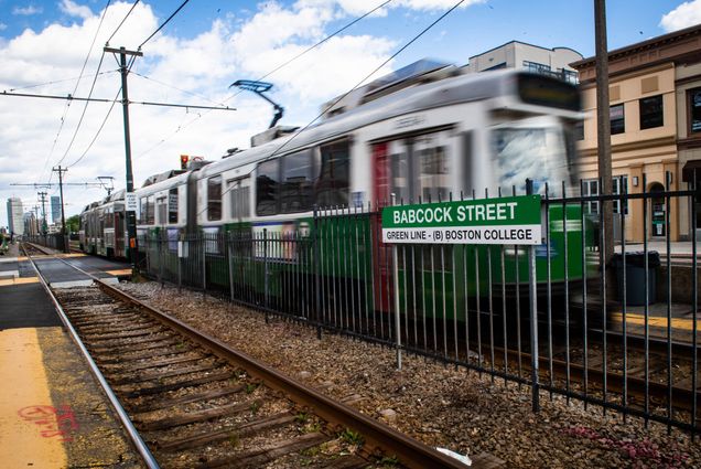 A photo of the MBTA green line running down Comm Ave.