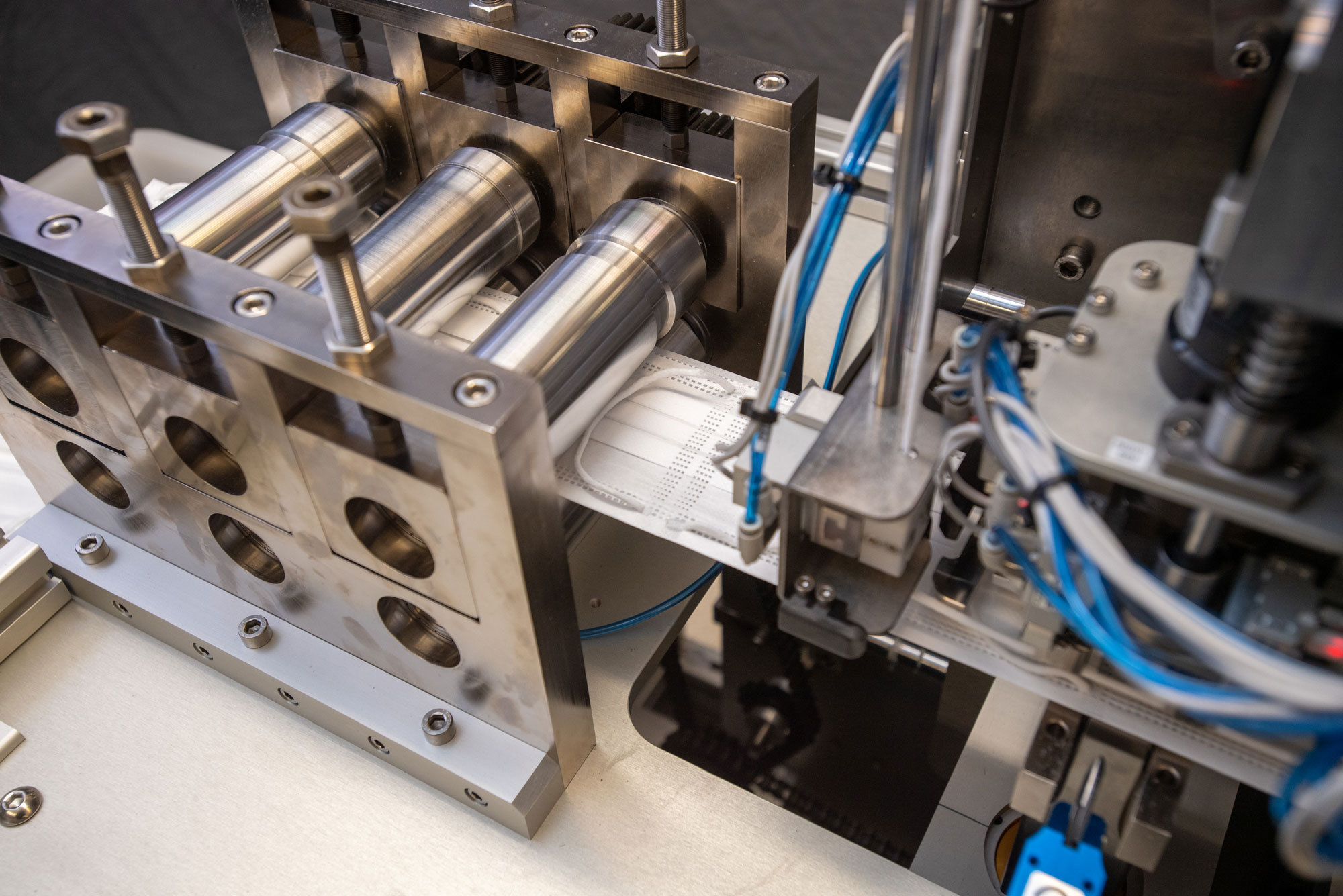 A photo of the mask making machine producing masks