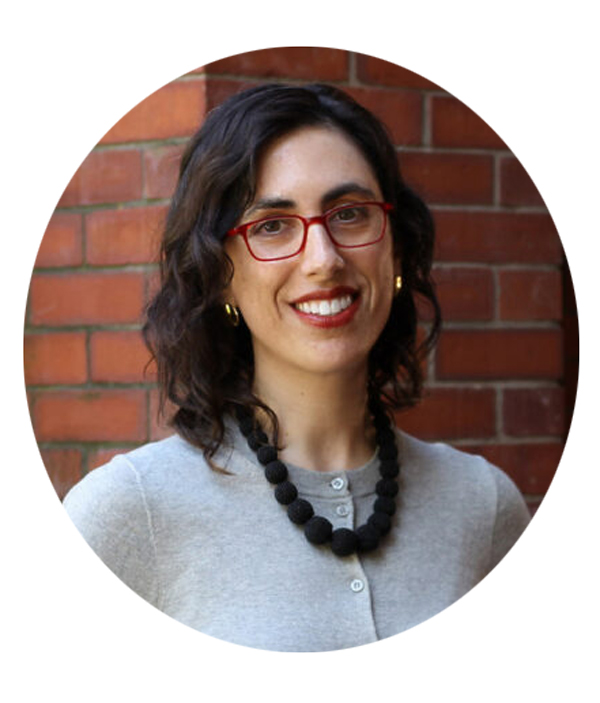 A headshot of Sarah Lipson smiling while standing in front of a brick wall