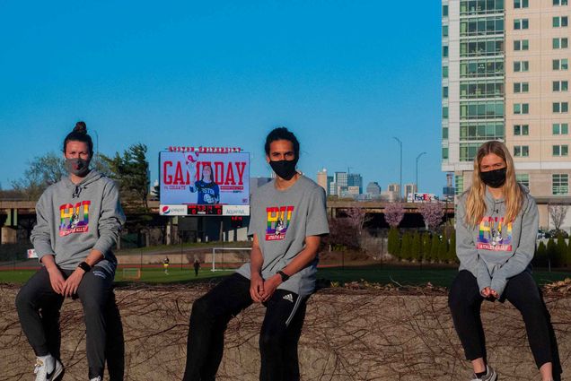 Portrait of Boston University Athlete Ally e-board members Sarah Wade (Sargent’21), Diego de la Torre (SHA’21), and Veronica Kriss (Sargent’21) sitting in front of Nickerson Field.