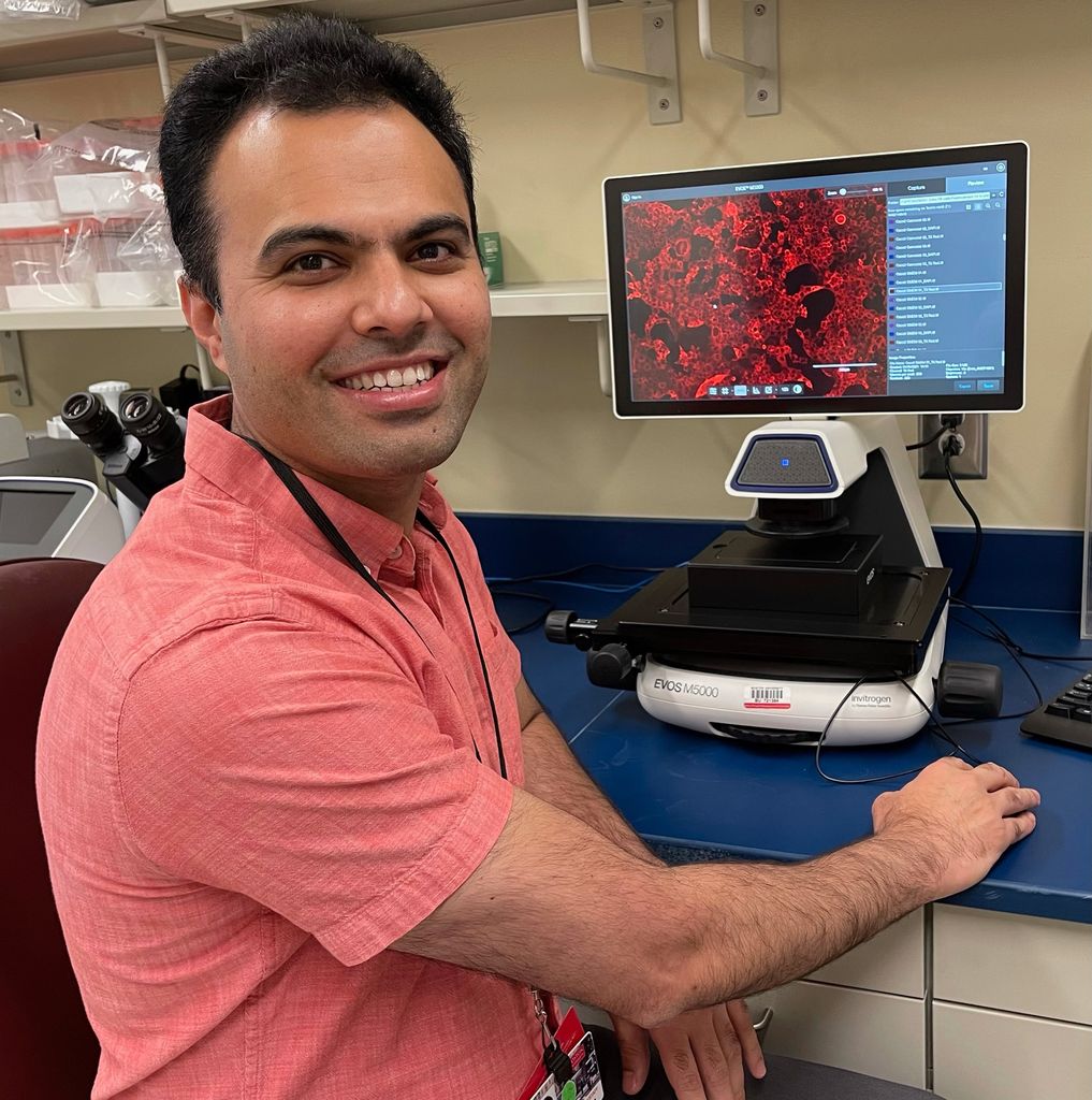 A photo of Mohsan Saeed working at a computer