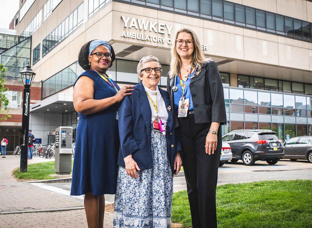 Boston Medical Center Grow Clinic codirectors Soukaina Adolphe and Megan Sandel with clinic founder Deborah Frank standing in front of Boston Medical Center.