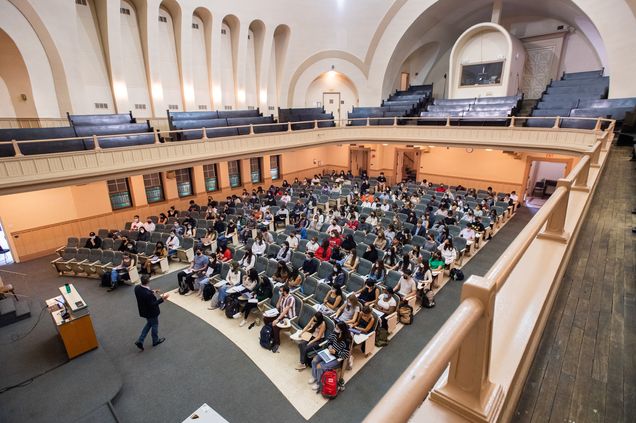 Wide elevated view of Uwe Beffert teaching a cell biology class in Morse Auditorium at Boston University on the first day of classes of the fall semester.