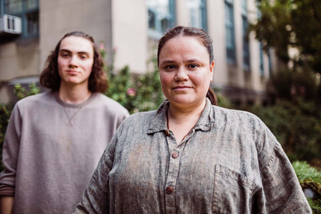 a photo of Erin Genia and her son, Sam, as they pose on the lawn near the GSU, where the sculpture is located.