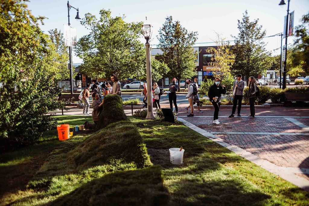 a photo of Passers-by stopping to watch as the sculpture took shape last week on the lawn by the School of Theology