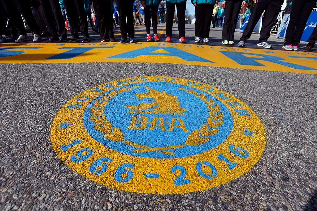 A seal honoring 50 years of women running in the Boston Marathon covers the street in front of the start line of the 120th Boston Marathon
