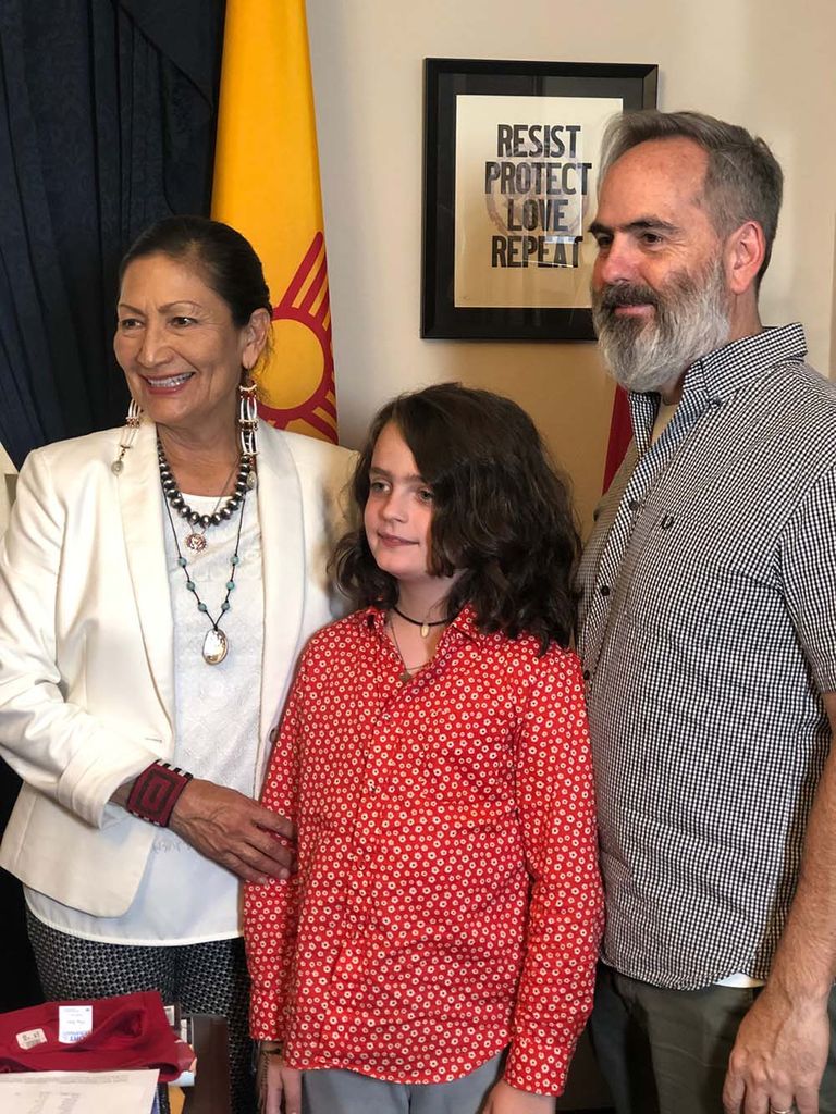 a photo of Cary and his son (right) posing for a photo with Haaland (left) after interviewing her for their film.