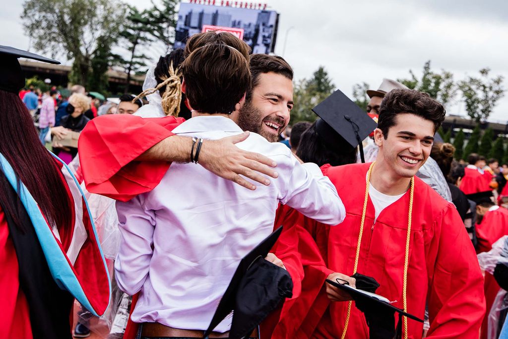A student hugs a family member or friend following Boston University's Commencement for the Class of 2020.