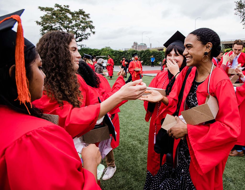 Class of 2020 students congratulate each other after Boston University's 147th Commencement ceremony on Nickerson Field.