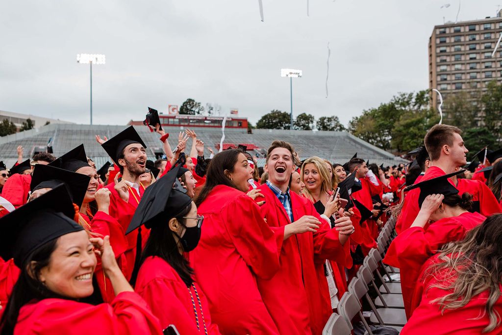 Class of 2020 students celebrate on Nickerson Field after being pronounced graduated.