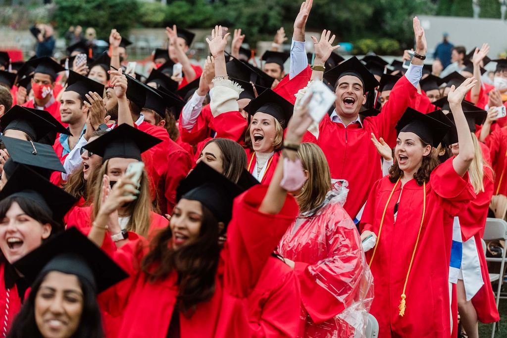 Class of 2020 students cheer during Boston University's 147th Commencement ceremony on Nickerson Field.