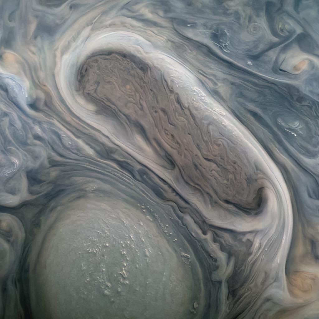 This image shows two of Jupiter's large rotating storms, captured by Juno's visible-light imager, JunoCam, on Juno's 38th perijove pass, on Nov. 29, 2021. This image was acquired at 50 degrees 5 minutes north latitude, at an altitude of 3,815 miles (6,140 kilometers). Atmospheric details as small as 2.5 miles (4 kilometers) can be discerned in the image. Bright "pop-up" clouds are visible above the lower storm, casting shadows on the cloud bank below. Although the pop-up clouds appear small in comparison to the large storm below, such clouds are typically 31 miles (50 kilometers) across. Citizen scientist Kevin M. Gill processed the image to enhance the color and contrast, using raw JunoCam data.