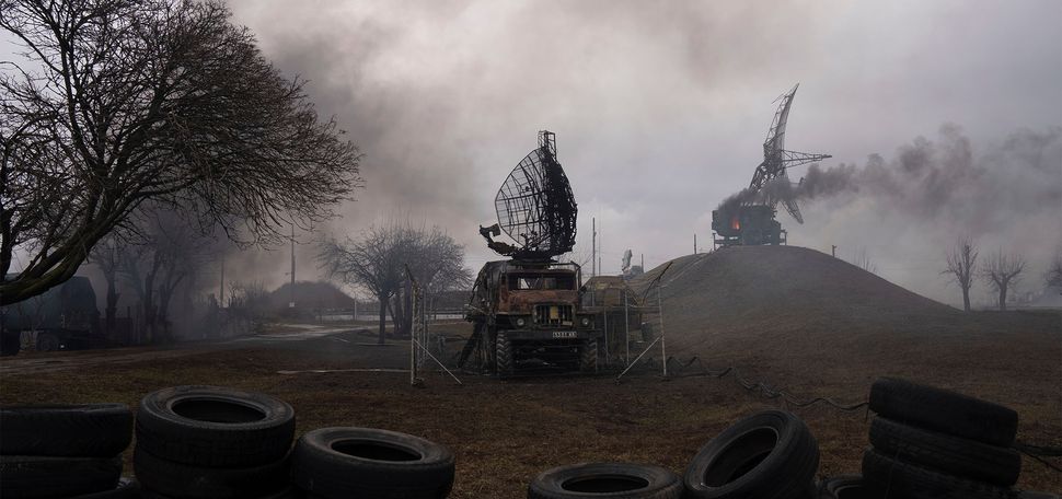 Smoke enveloped a Ukrainian air base in Mariupol after a Russian strike Thursday, part of Vladimir Putin’ invasion of his neighbor. Photo by AP/Evgeniy Maloletka