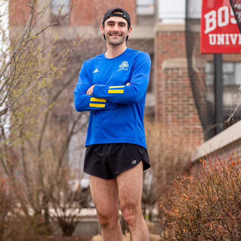 Ken Vinacco is raising money for the National Multiple Sclerosis Society’s Finish MS initiative. His mother was diagnosed with MS in 2005. Here Ken is wearing running shorts and a blue marathon shirt in front of a brick background
