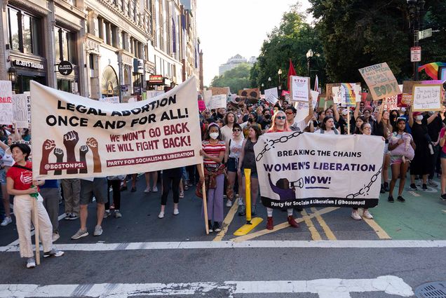 Photo of a large crowd of women holding signs protesting the SCOTUS Roe v. Wade decision at the intersection of Tremont Street and Boylston Street in Boston during the rally.