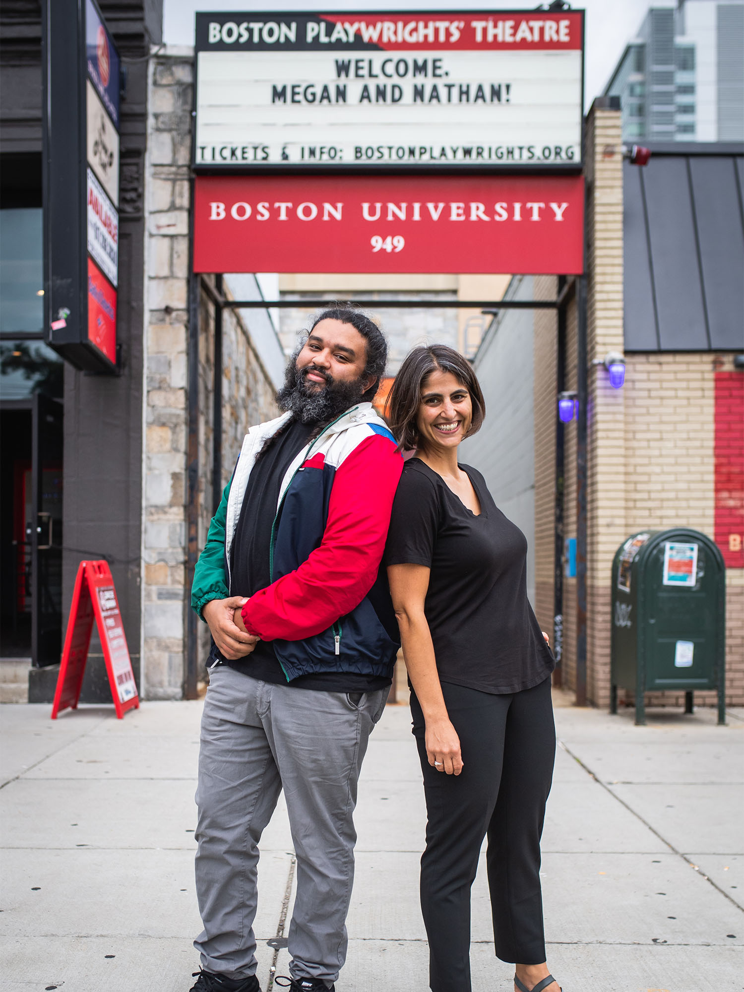 As a CAS associate professor of the practice of playwriting, Nathan Alan Davis will run the University’s MFA Playwriting Program, and Megan Sandberg-Zakian is the new artistic director of Boston Playwrights’ Theatre. Here the two stand back to back on Commonwealth Ave outside the theatre. Photo by Jackie Ricciardi