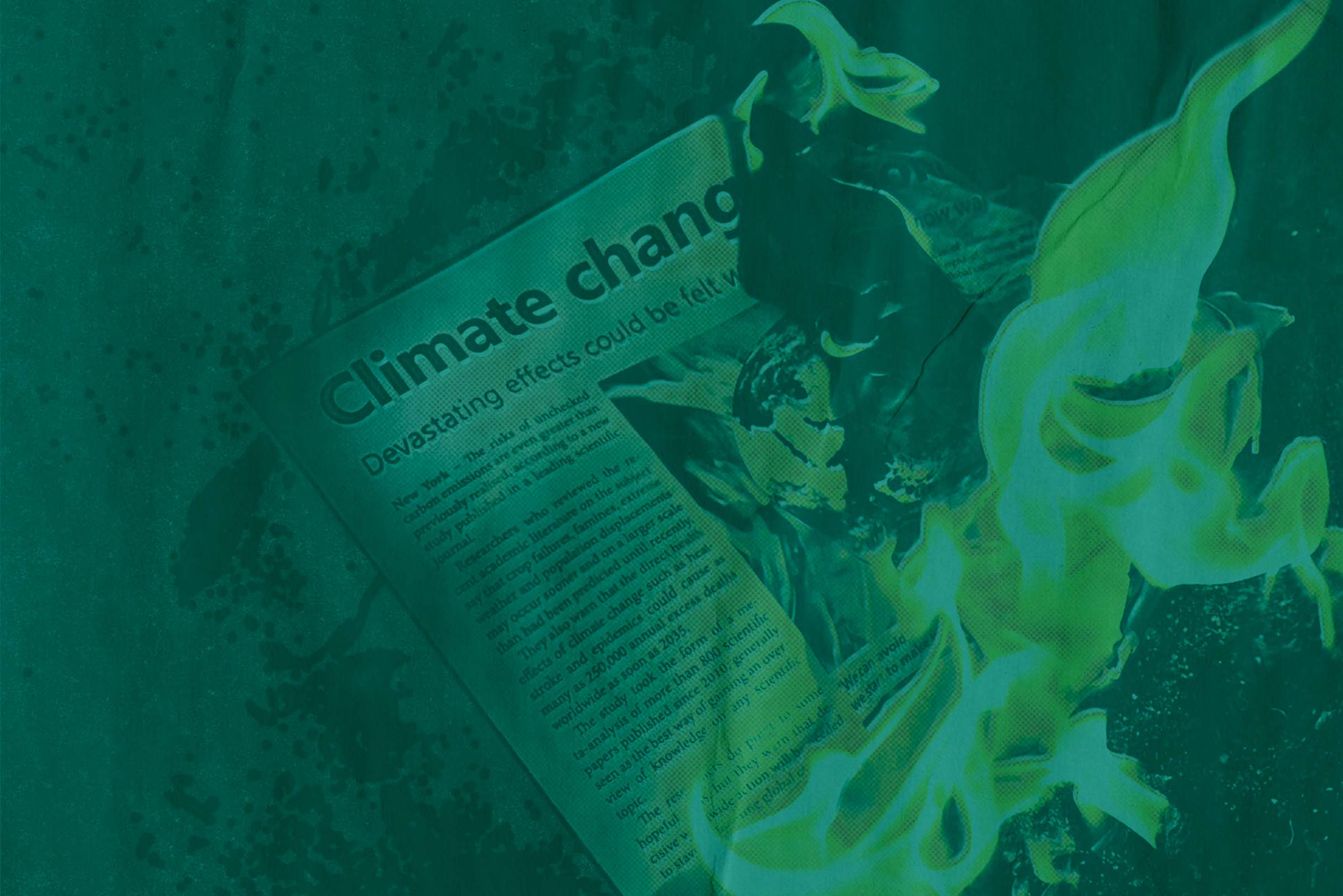 A newspaper burns. On the page the words Climate Change can be seen burning. The image has a greenish tint to it