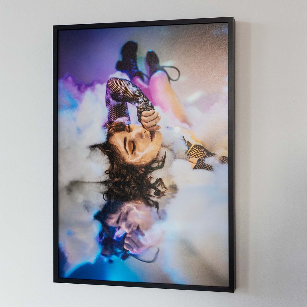 “Daydreams” (2017) by Jaina Cipriano. A work of art on a white background. The art contains a woman in a landscape of clouds
