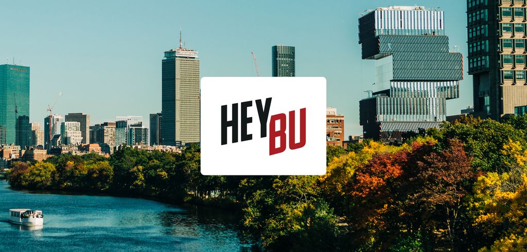 View of the Boston skyline and the Boston University Charles River Campus from the Charles River. Text embedded on the photo says 'Hey BU'