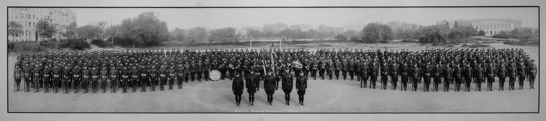 A 1920s photo of the BU ROTC Band surrounded by members of the Reserve Officers Training Corps. Original photo by Fairfield Studio, Boston