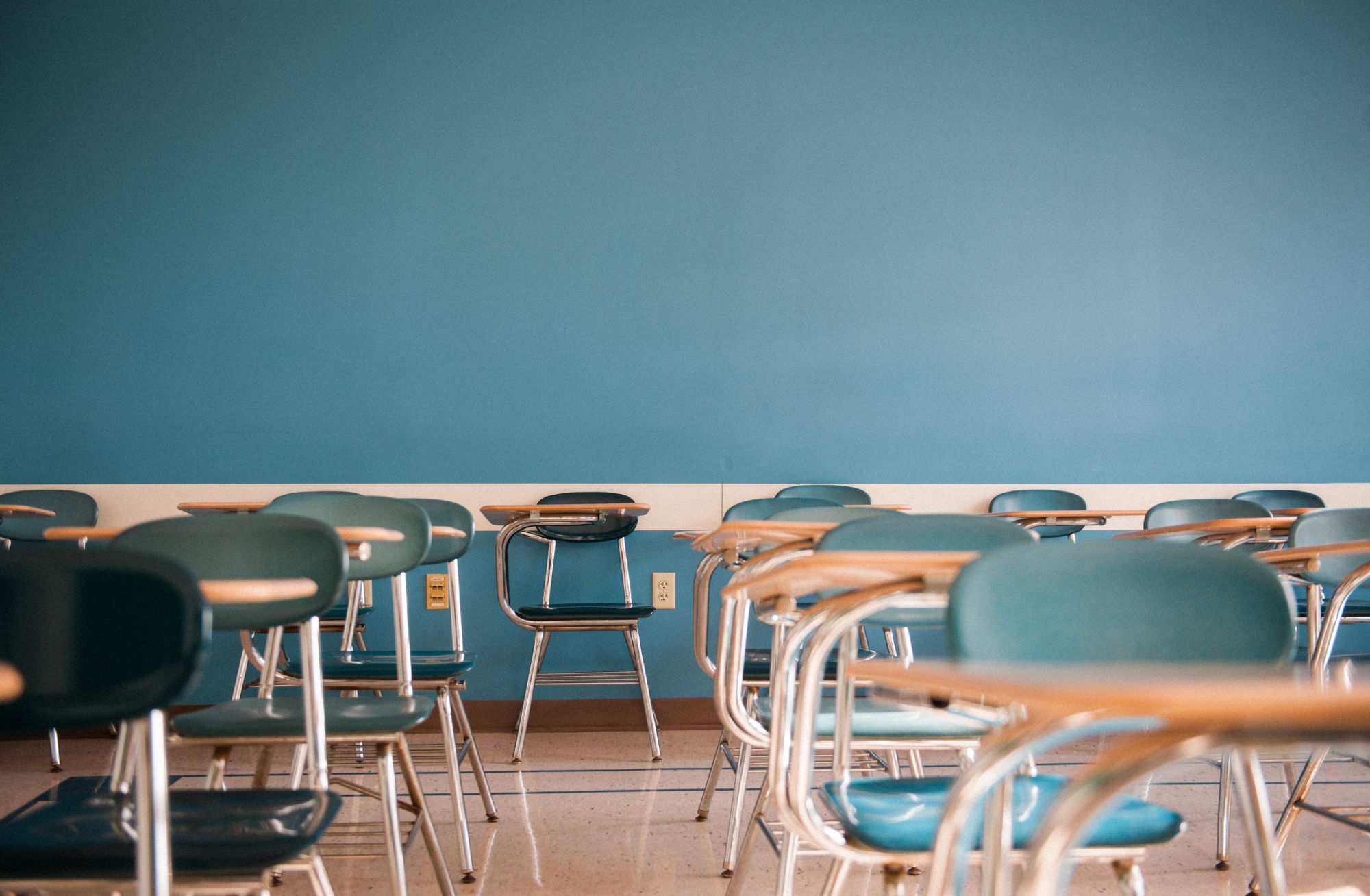 A photo of a classroom on Boston University's campus with multiple empty desks.