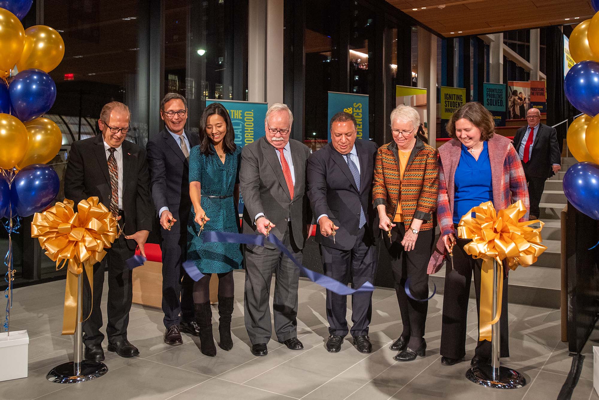 Photo: The Ribbon cutting to officially open the Center for Computing and Data Science Dec 8. From left are Associate Provost for Computing and Data Sciences Azer Bestavros, CAS dean Stan Sclaroff, Boston City Mayor Michelle Wu, President Robert A Brown, Board of Trustees chair Ahmass Fakahany (Questrom’79), Provost Jean Morisson, and Boston city councilor Kenzie Bok. They all stand with scissors in hand looking down as a cut blue ribbon floats to the ground.