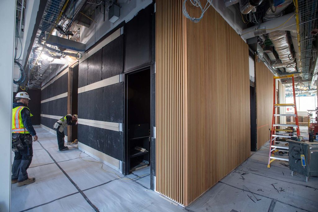 Photo: Interior of the Center for Computing and Data Science as work continues to be done. A half built wall with wooden slat paneling is shown.