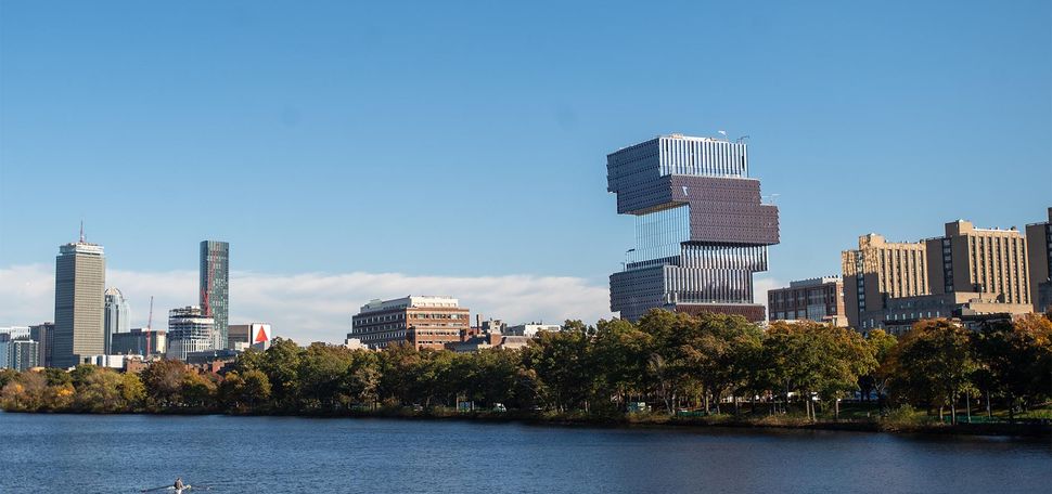 Photo: A photo of the CCDS on Boston University's campus. It is shown from across the Charles River, among the Boston skyline.