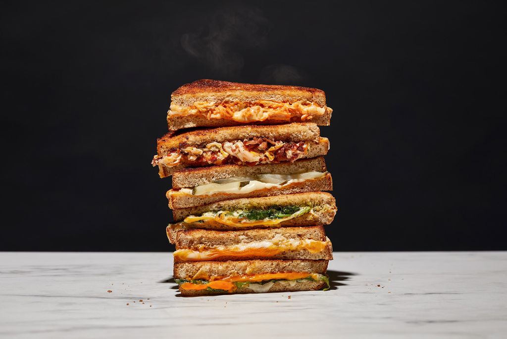 Photo: A stack of grilled cheese sandwiches with various toppings