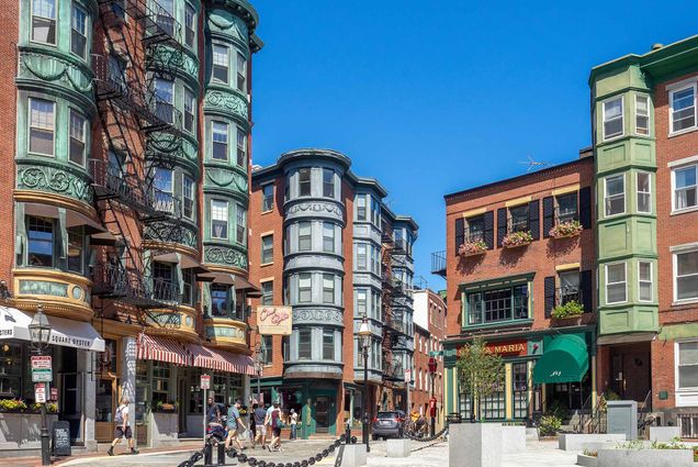 Photo: A bustling square in Boston's North End, surrounded by brick buildings