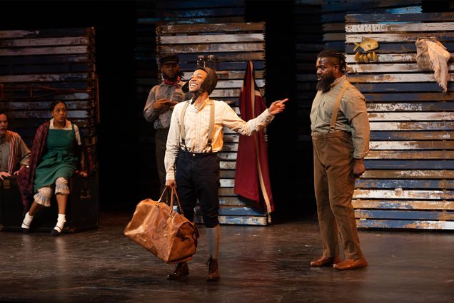 Photo: Anderson Stinson III, a black man wearing a camp and suspenders with trousers, center stars in the play as Bud with David Jiles Jr., right, during rehearsal at Wheelock Family Theatre, Wednesday, April 12, 2023. Photo by Jake Belcher