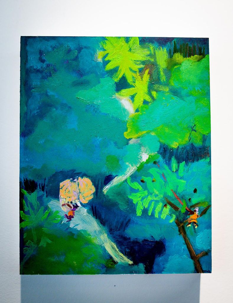 Photo: Painting by Asjha Malcolm is displayed. Painting features abstract green and blue scenes of what looks to be small figures walking up asteep, forest mountain path.