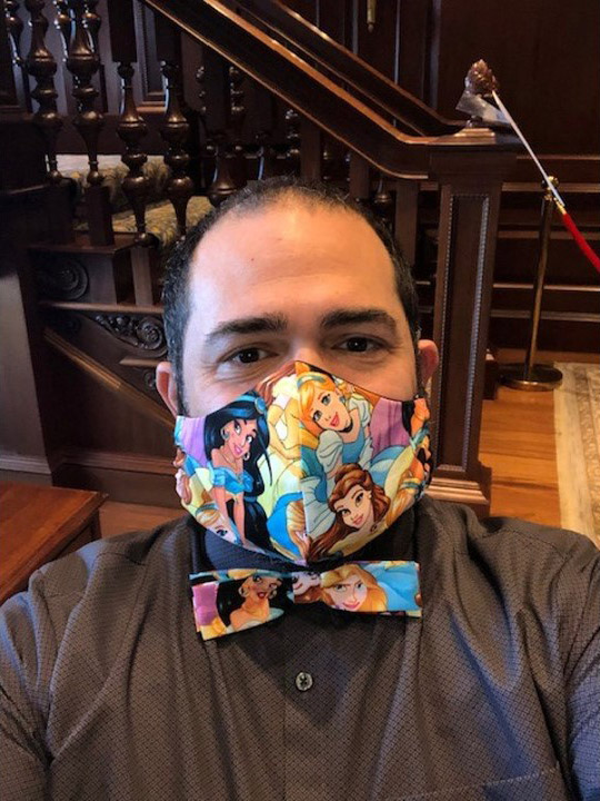 Photo of Jesus Nater with a matching mask and bowtie that have disney princesses on them.