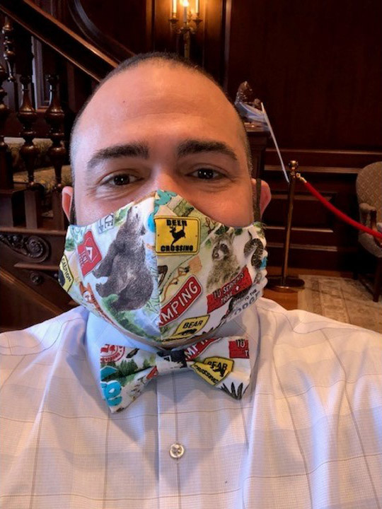 Photo of Jesus Nater with a matching mask and bowtie made with a white fabric with animals and animal crossing signs on it.