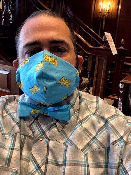 Photo of Jesus Nater with a matching mask and bowtie that is light blue with yellow bats on it.