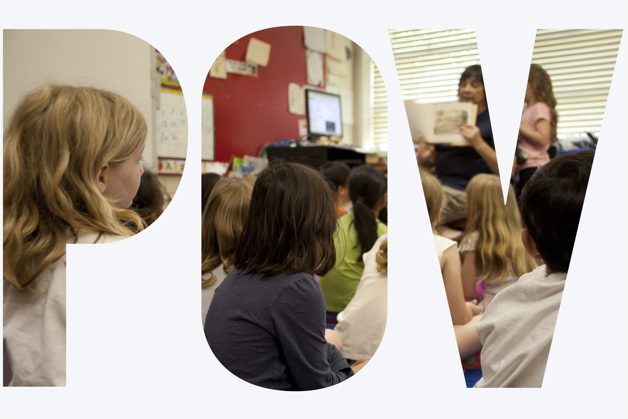 Photo: a group of small children in a classroom sit on a carpet and face towards their teacher who is showing a book they're reading to the class. Image seen through transparent "POV" letters on a white background.