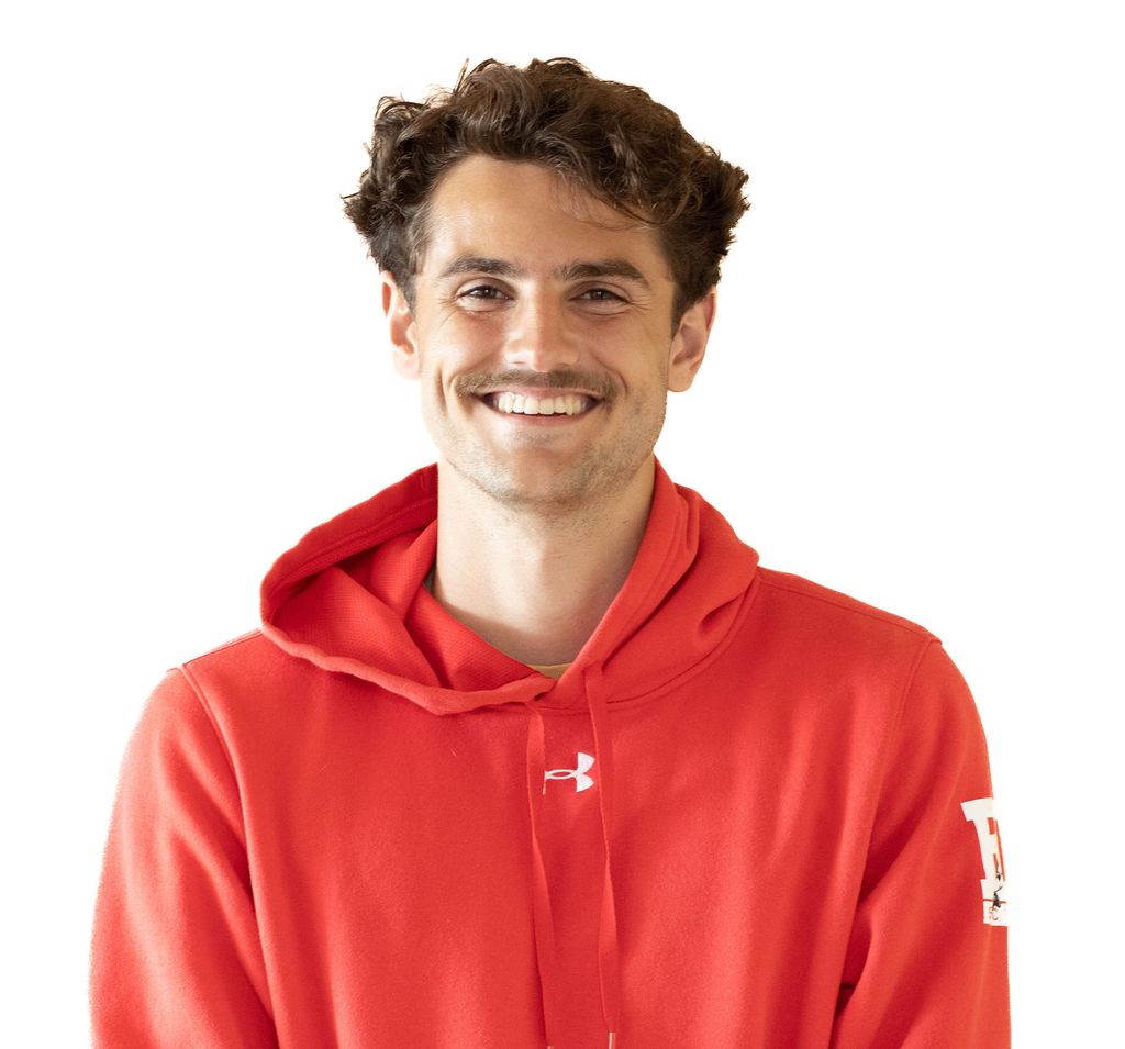 Photo: Headshot of Francesco Montali. A young white man with curly brown hair and wearing a red Boston University hooded sweatshirt poses in front of a white background.