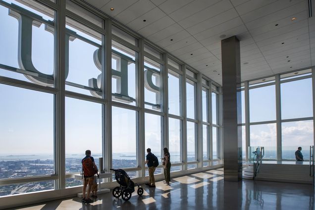 Photo: Visitors look outside of the View Boston's 24-foot high floor to ceiling windows that provide a 360 degree view of the city.