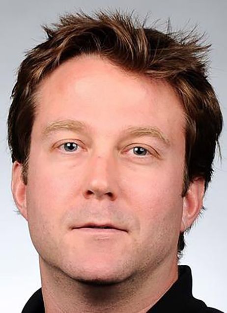 Photo: A white man with short brown hair stares at the camera for a headshot.