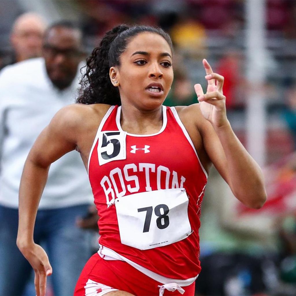 Photo: A runner in Boston university red wearing number 78 sprints on an outdoor track