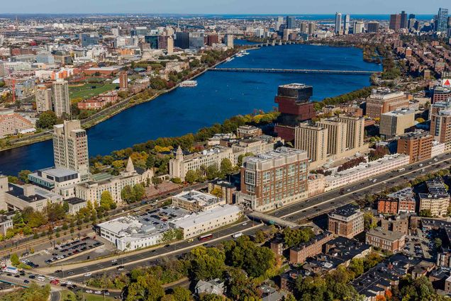 Photo: Aerial shot of Boston University's campus during sunset. An orange glow is shown on the large campus highlighting campus buildings and it's location in Boston.
