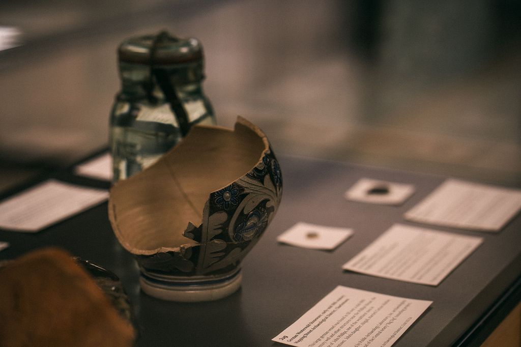 Photo: A broken black vase is shown on display on a lack table at the new Mary C. Beaudry Community Archaeology Center.