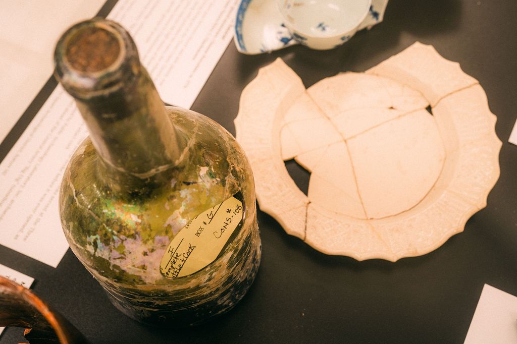 Photo: An old glass vase is shown displayed on a black table.