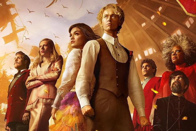 Photo: A crop image of the movie poster for The Ballad of Songbirds and Snakes. Seven individuals pose dramatically, looking to the left. The two main characters are in the center with their backs to one another. The setting for the games is in the background.