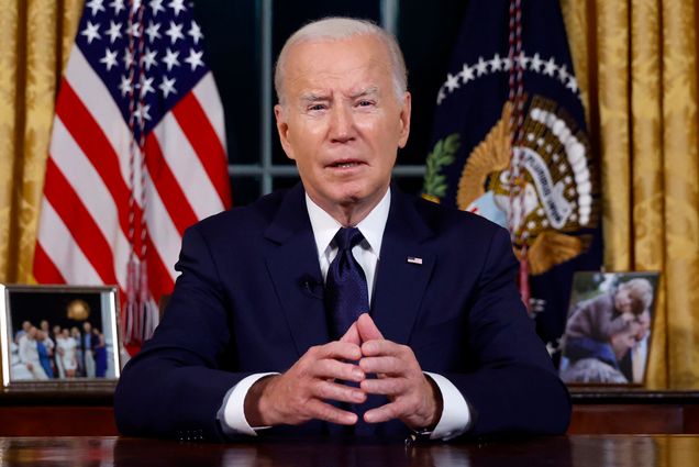 Photo: A photo of President Joe Biden speaks from the Oval Office of the White House. He is mid speech, clasping his hands, and wearing a dark suit.