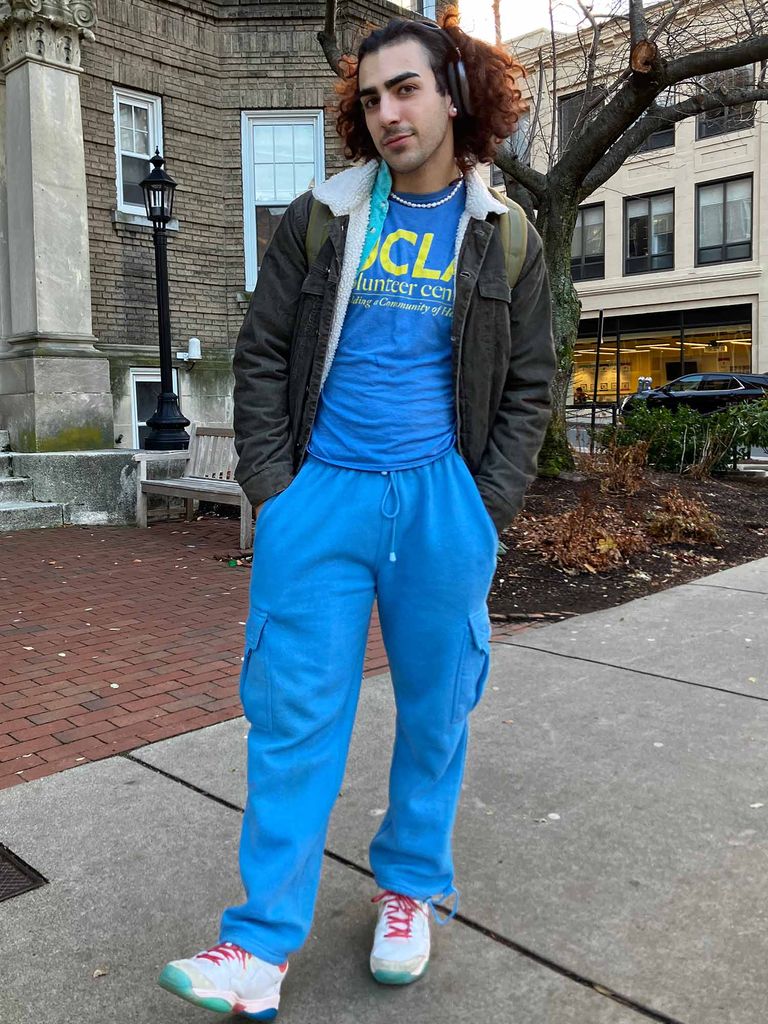 Photo: A college student with curly hair wearing a baby blue UCLA track suit and sneakers
