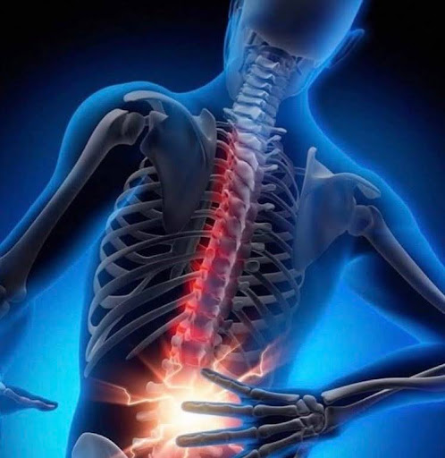 This is an x-ray photo of back pain. The spine is red and has as white flash where the person is holding their back, as if they are in pain.