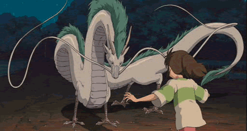 Gif from the movie "Spirited Away". A child is running up to give the animated dragon a hug on the head.