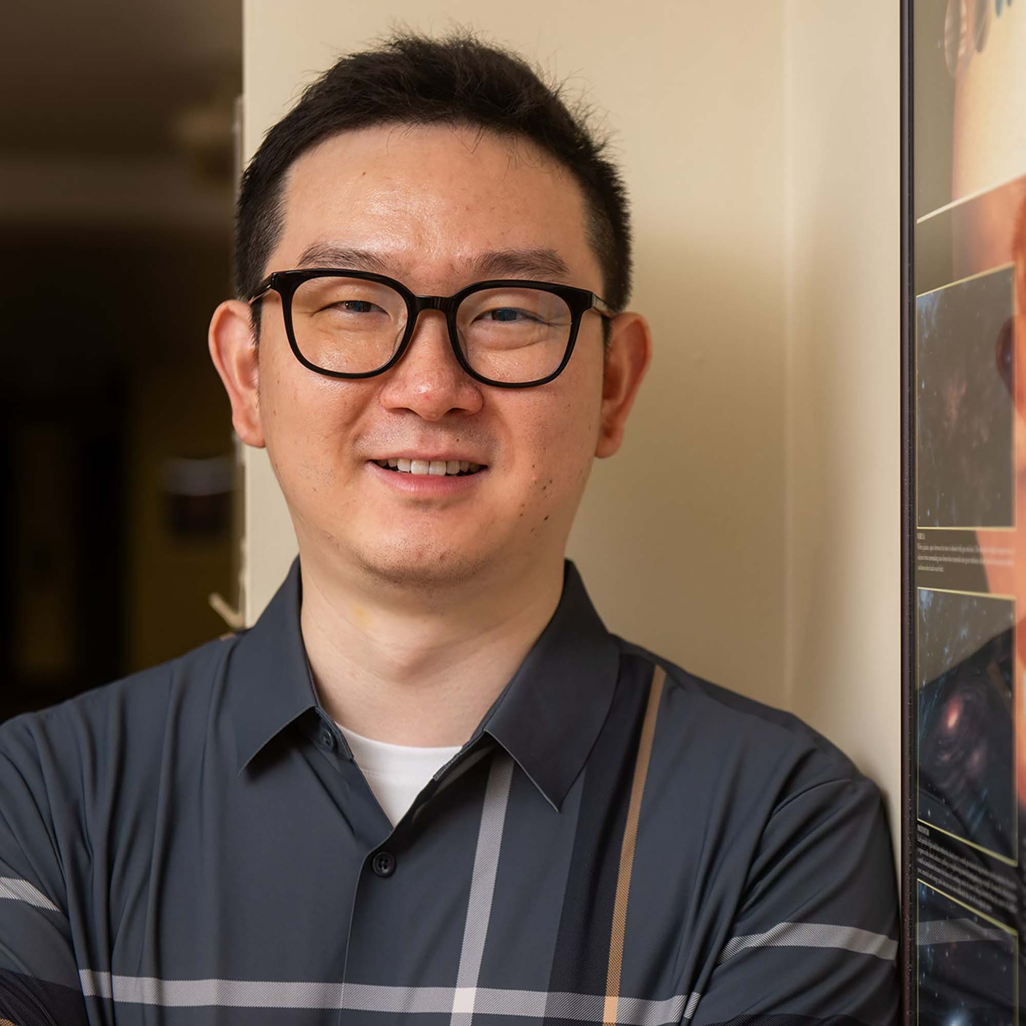 Photo: Chuanfei Dong, a man with short dark hair, glasses, and a collared cotton shirt.